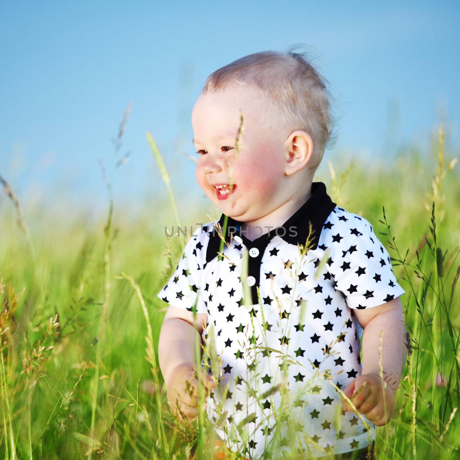 boy joy in green grass