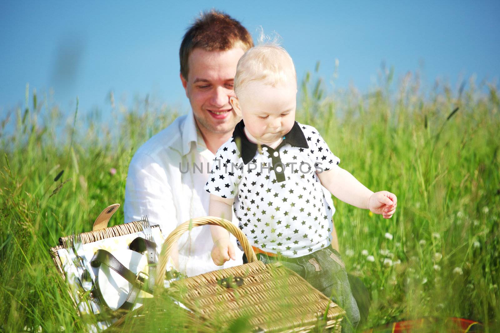 father and son in the grass