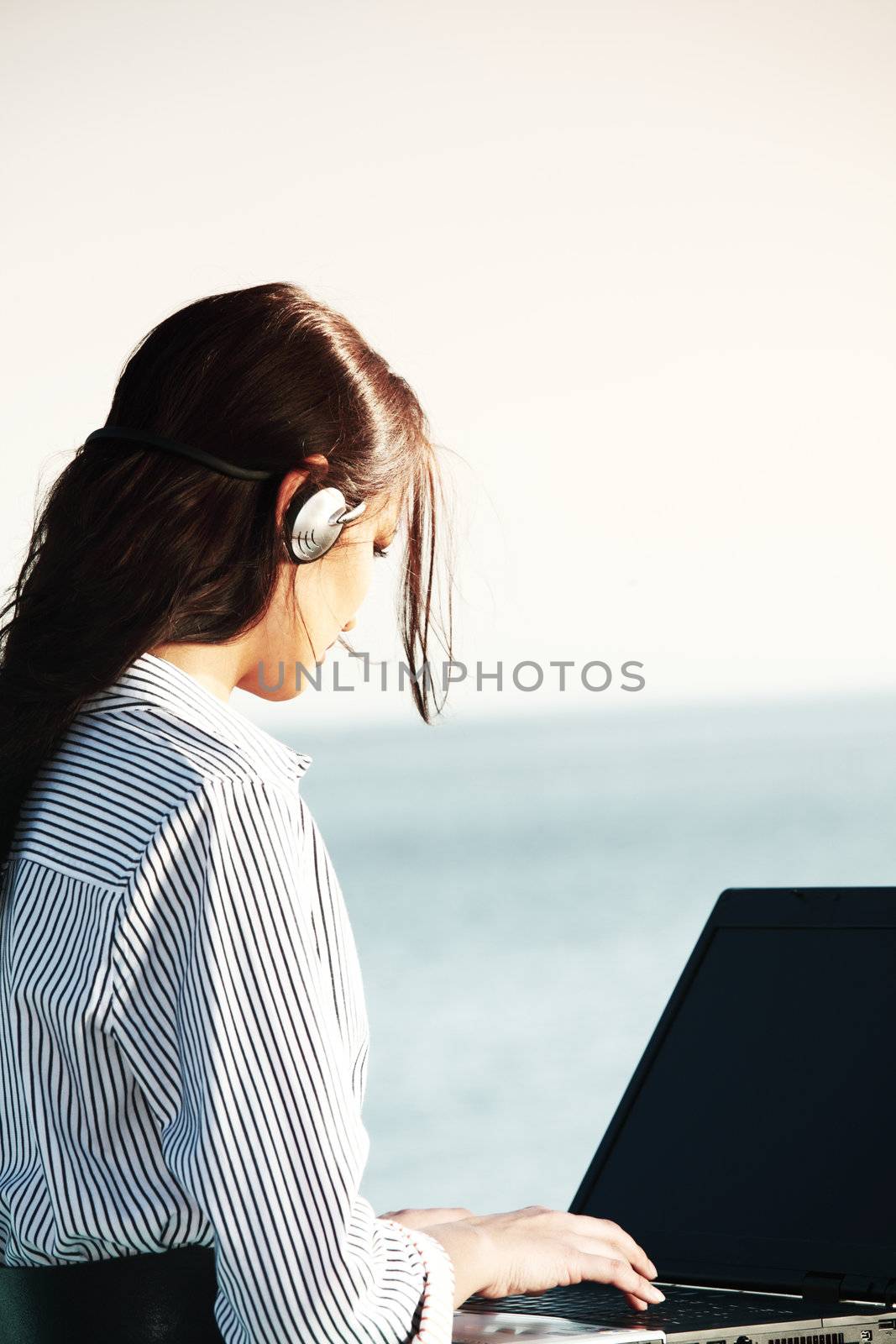 woman work on laptop sea on background