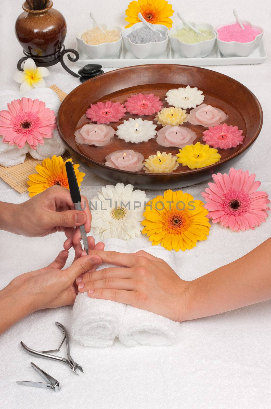 Male manicurist doing manicure to a female customer in a spa