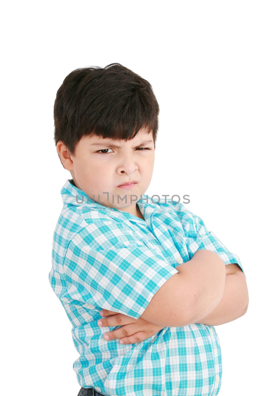 serious little boy with hands folded standing isolated on white background