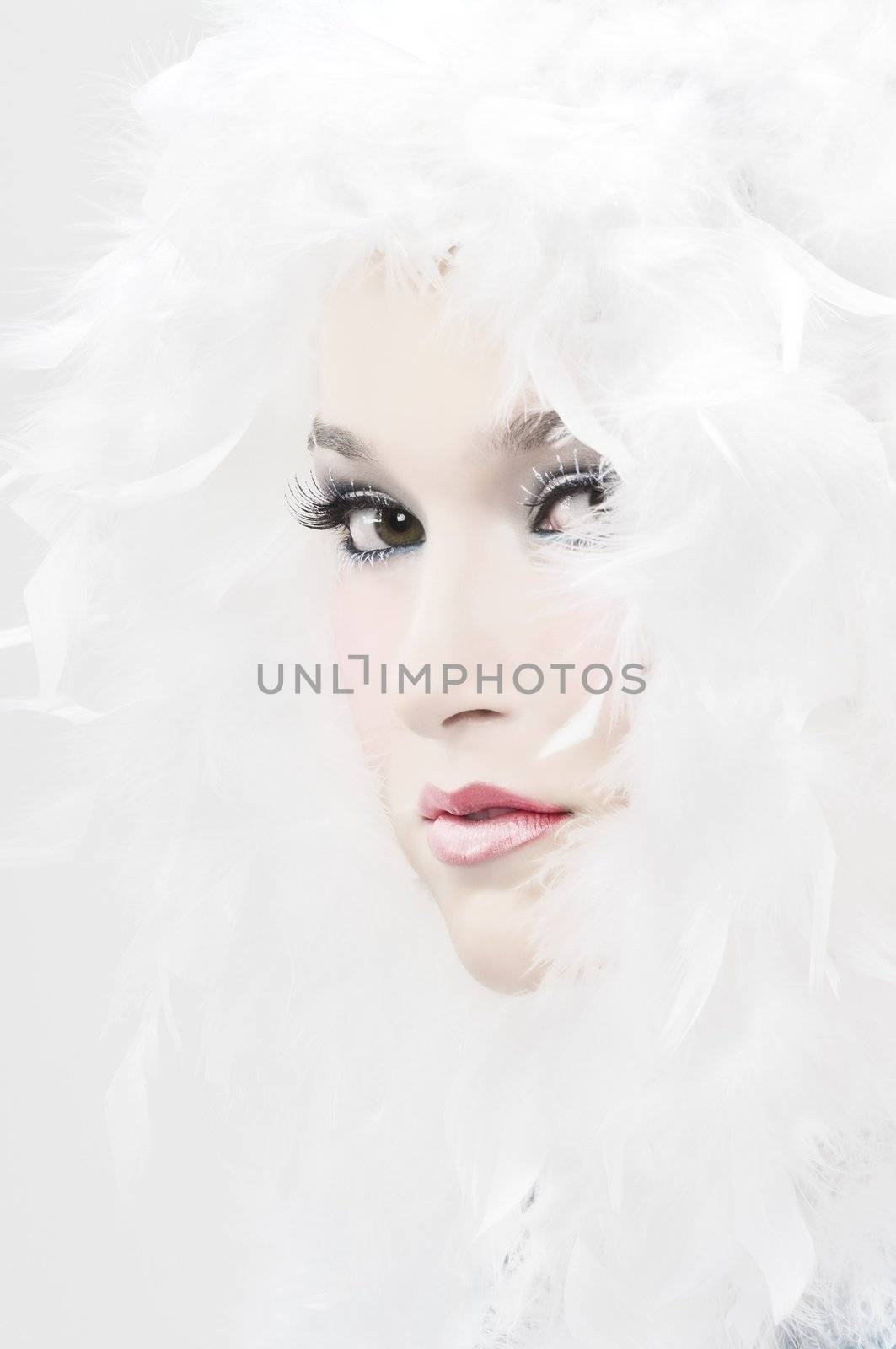Girl with beautiful make up and white feathers