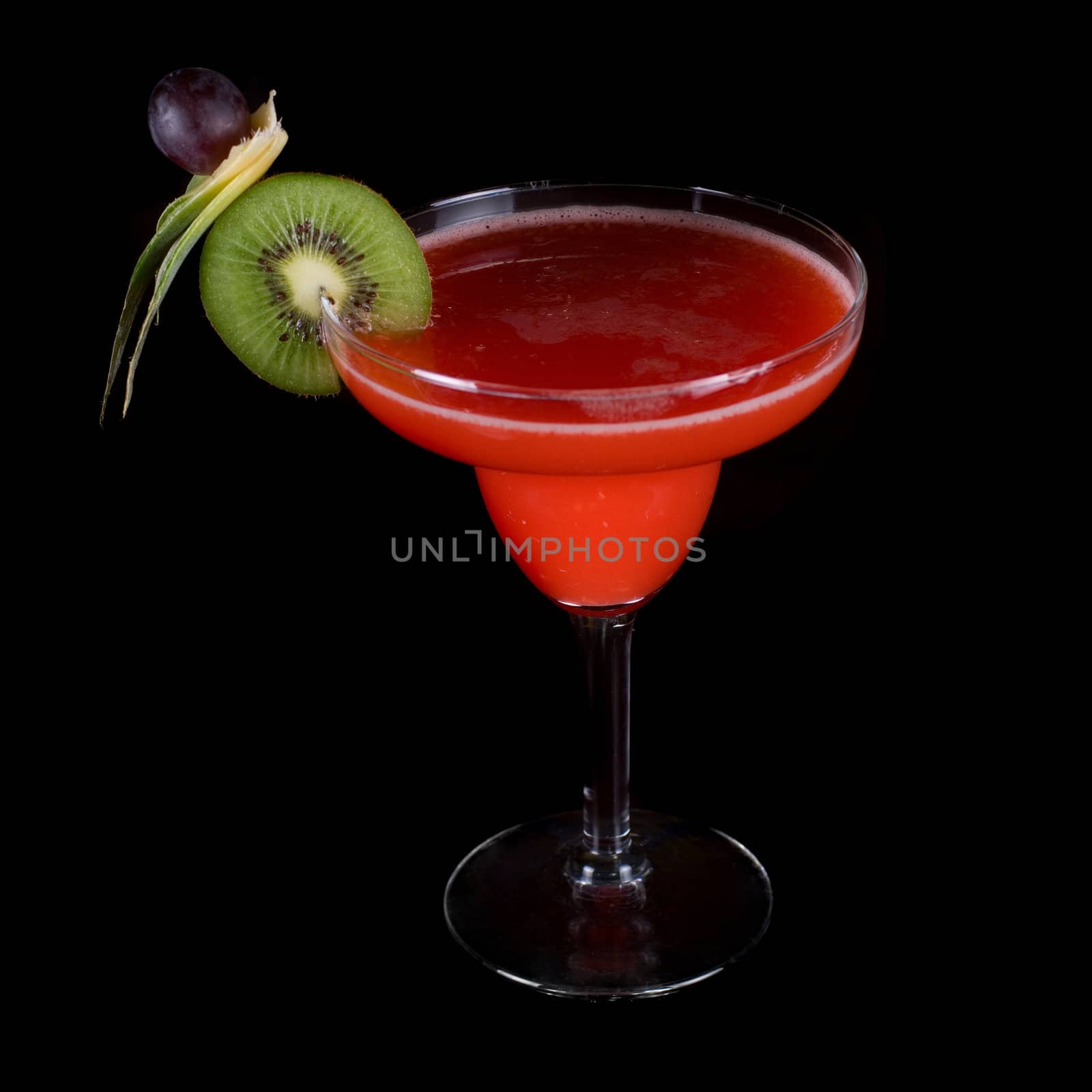 red cocktail with kiwi on a black background