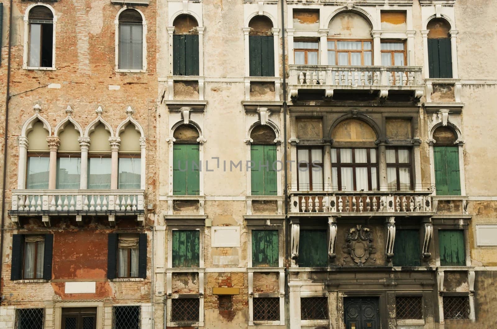 The facades of Venetian houses with balconies and windows