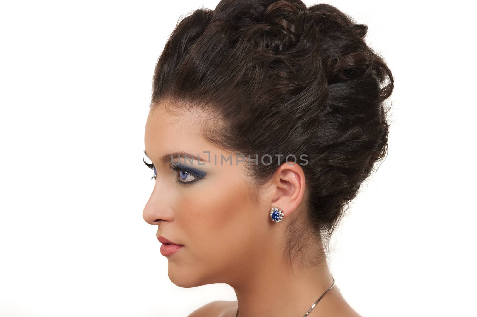 Young woman with beautiful hairstyle, make up and sapphire jewelry