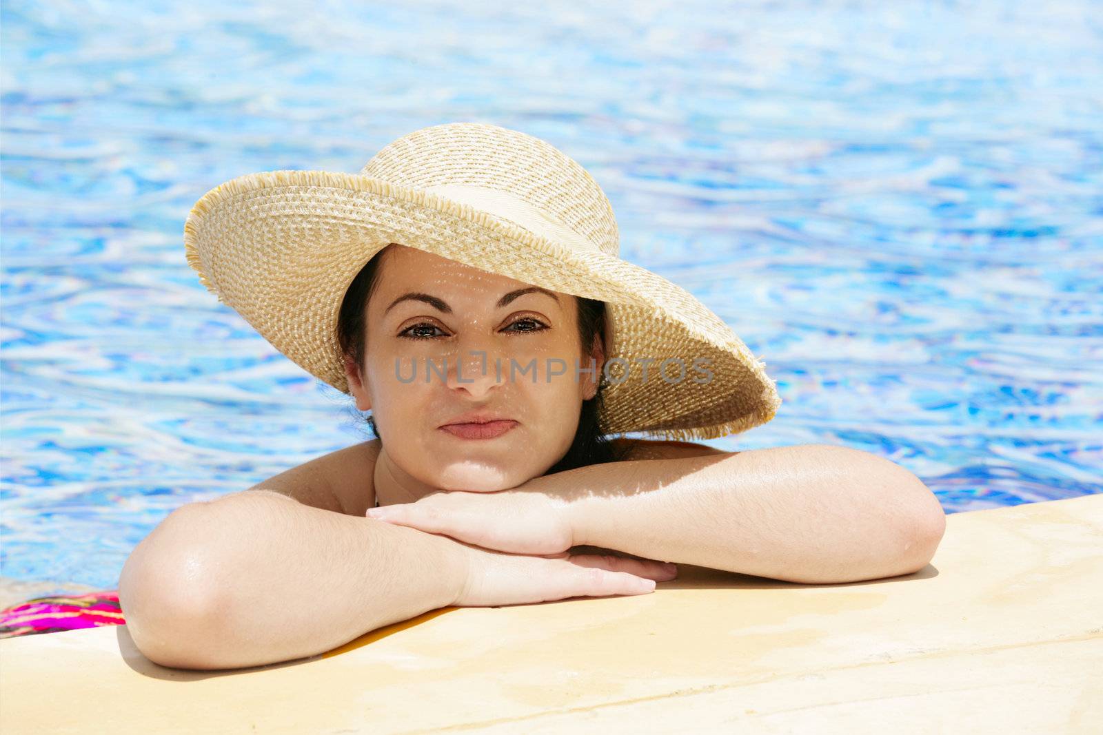 young beautiful woman at the pool in summer