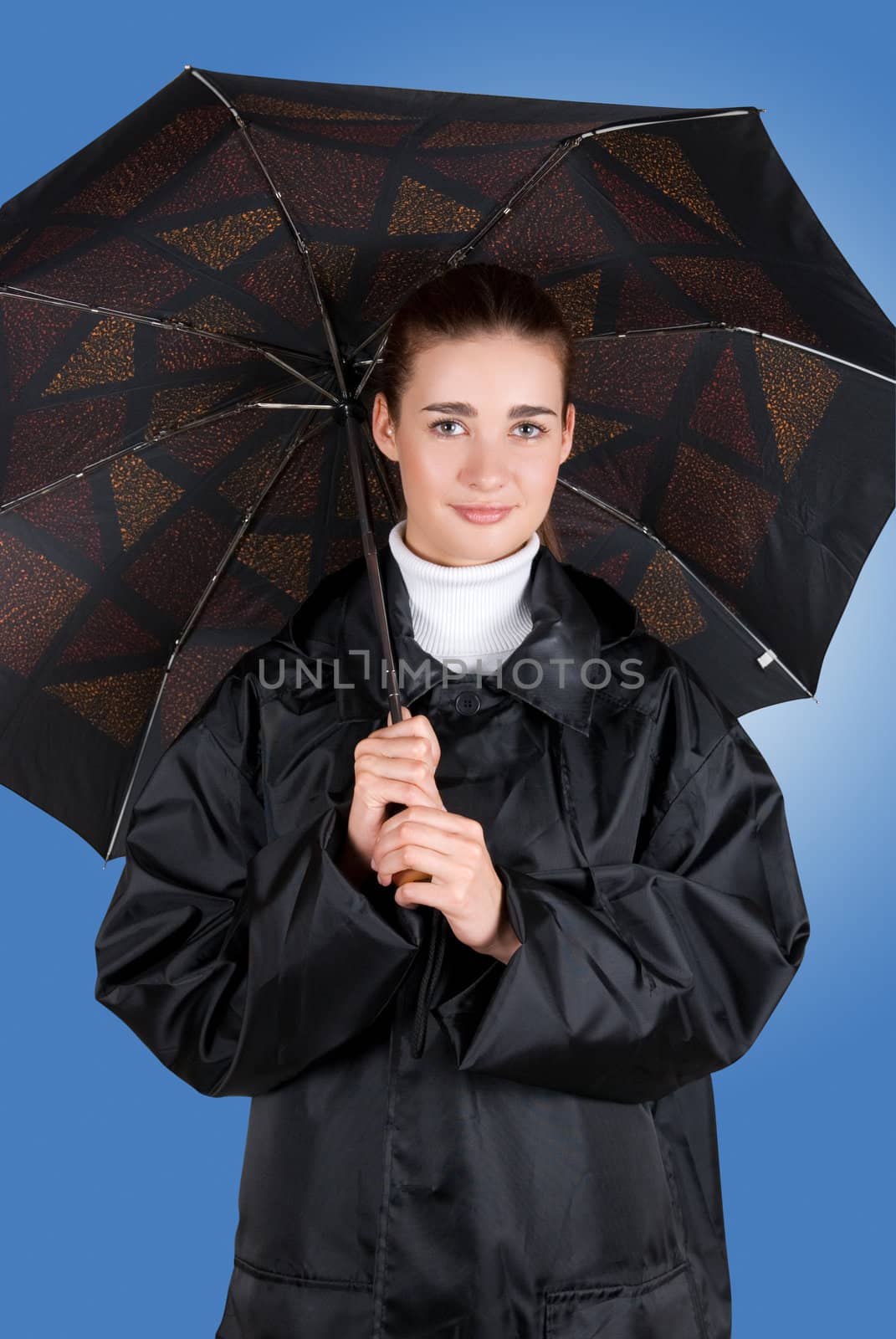 pretty brunette girl at black coat under umbrella