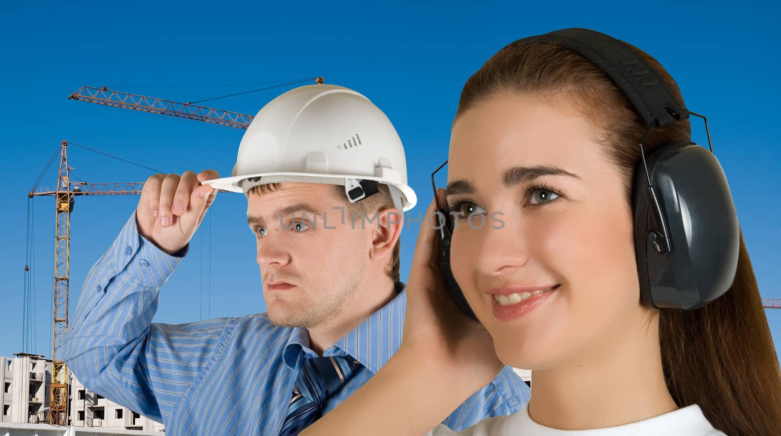 Portrait of young architects at in front of construction site, building and crane.