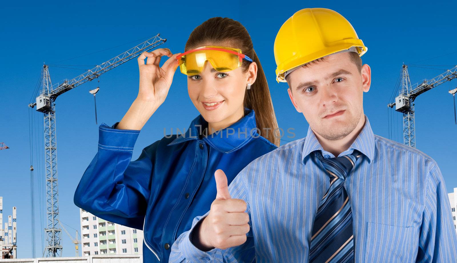 Portrait of young architects at in front of construction site, building and crane.