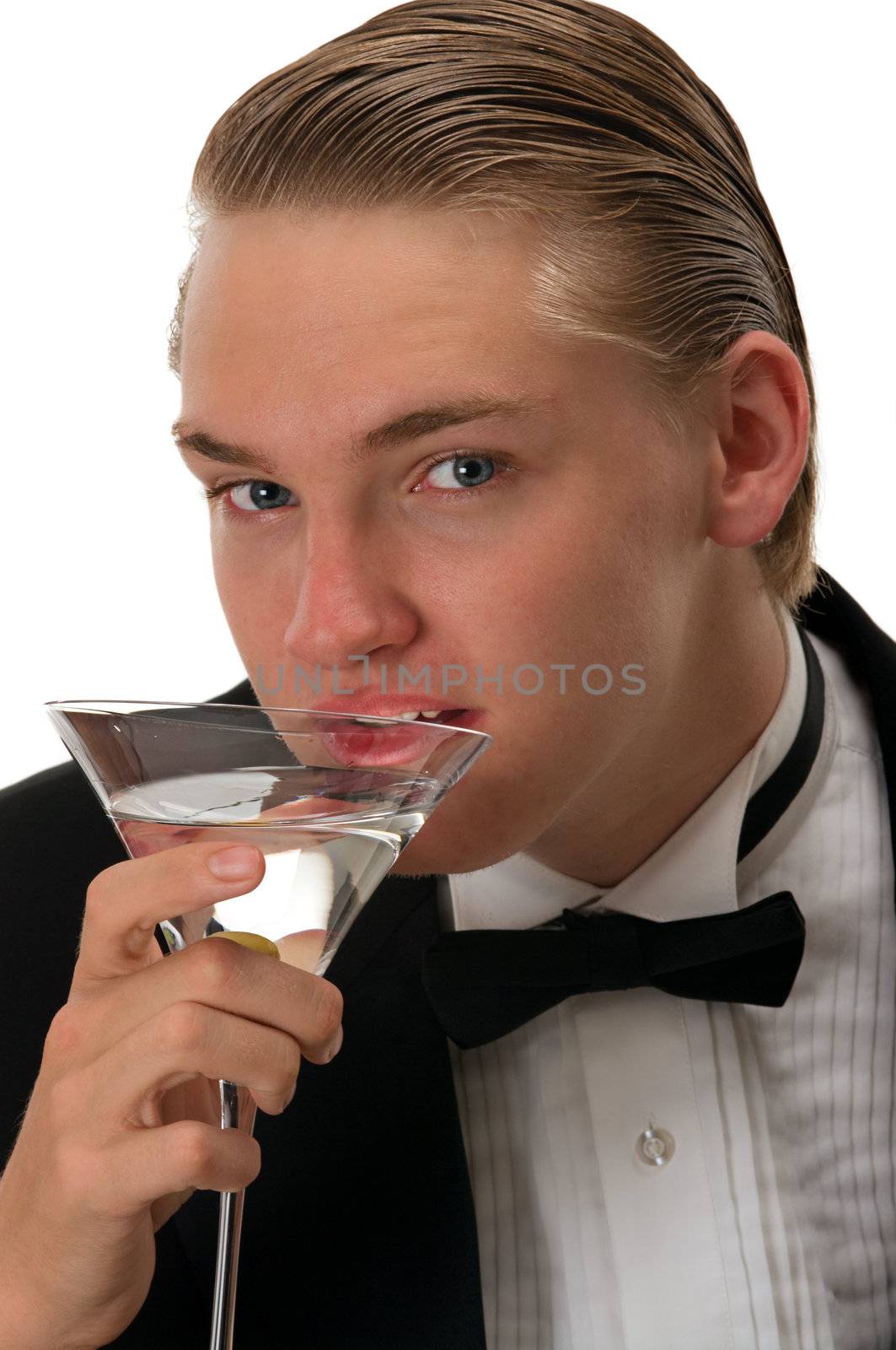 Handsome young man drinking martini