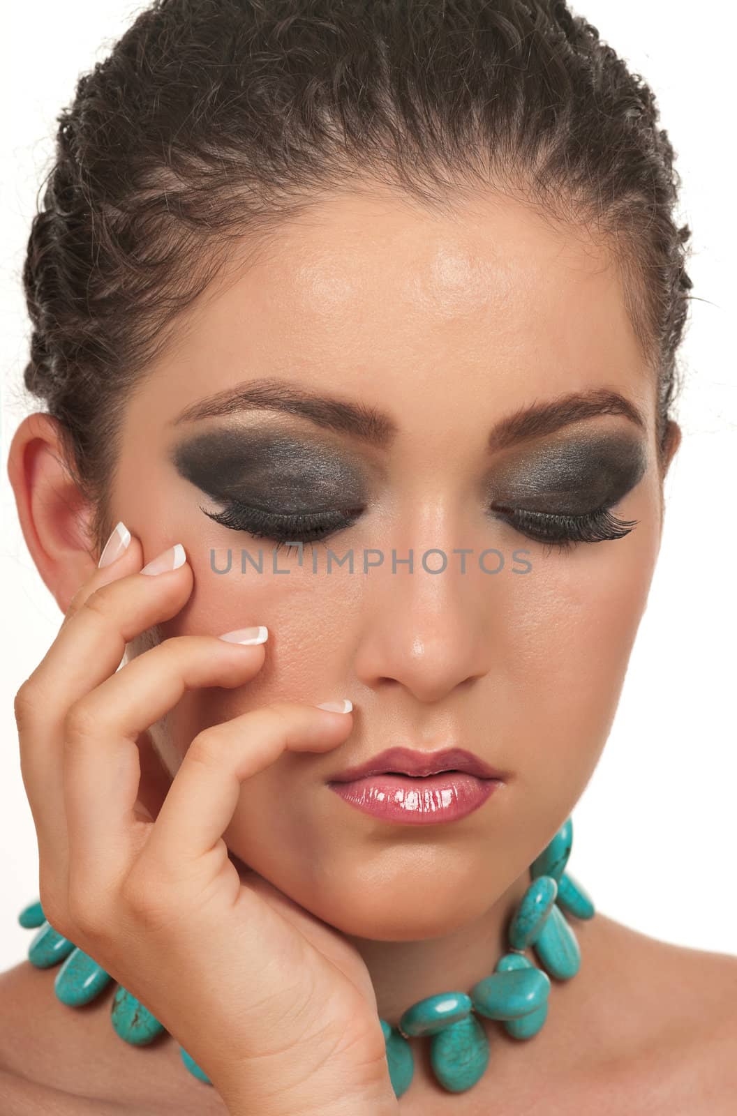 Girl with beautiful make up, necklace and manicured hand