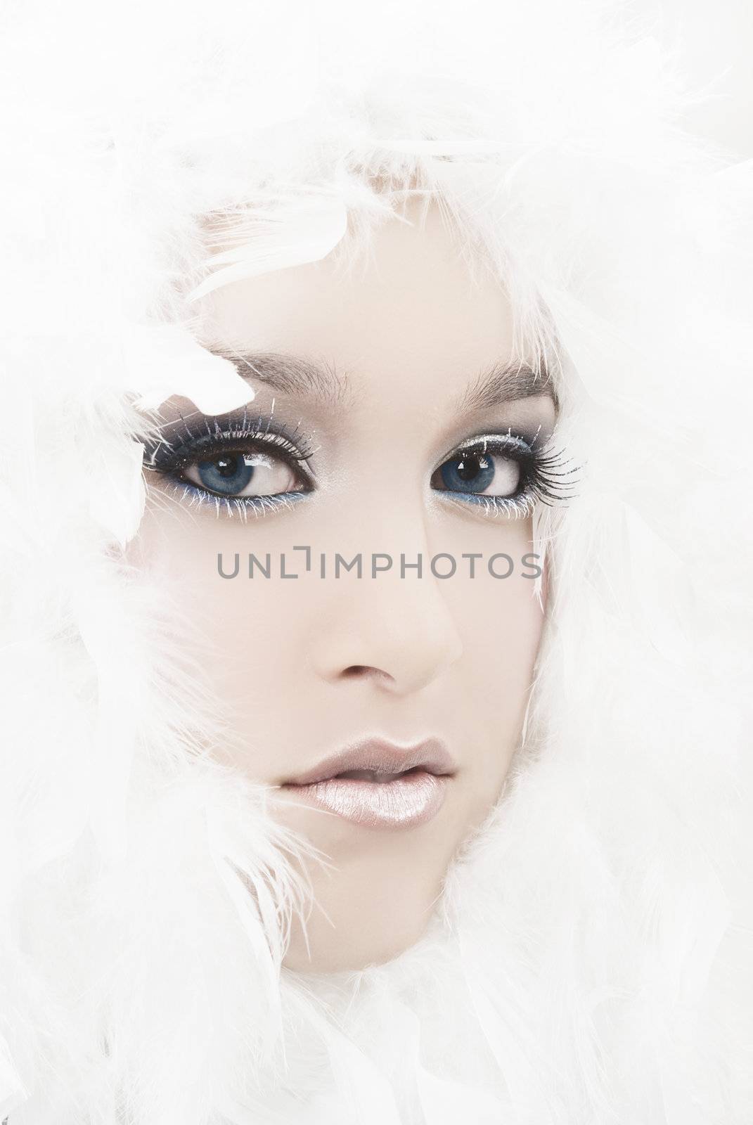 Girl with beautiful make up and white feathers