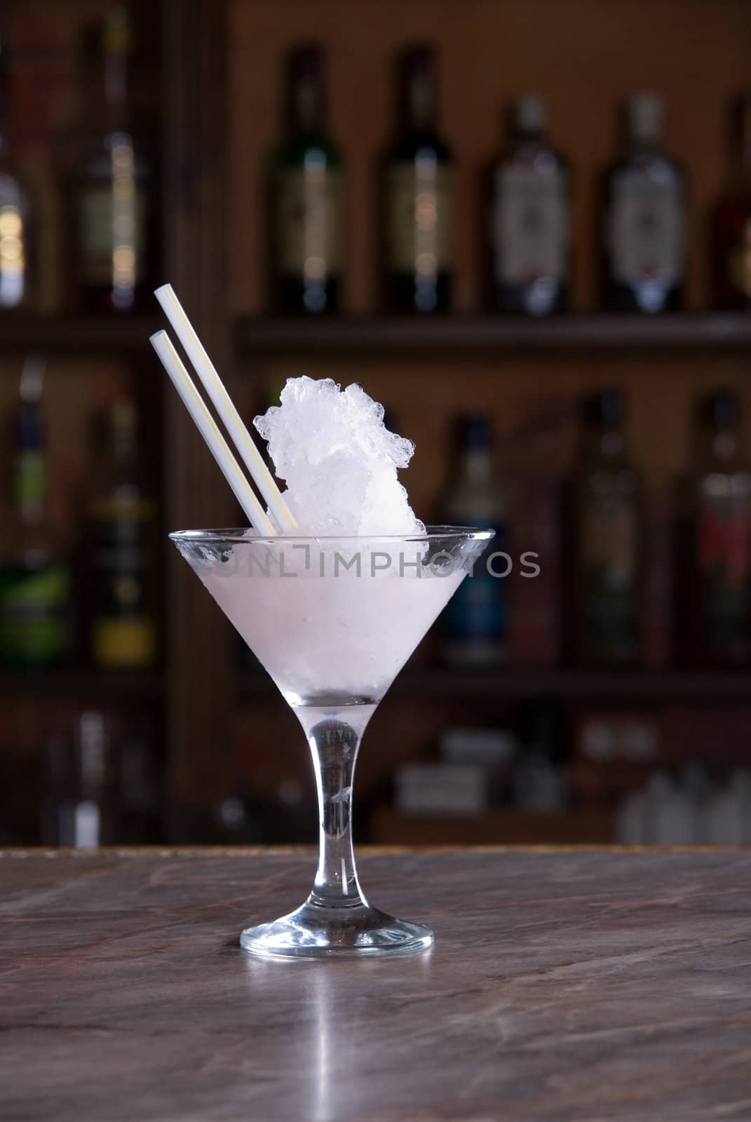 pink frozen cocktail on the wooden bar