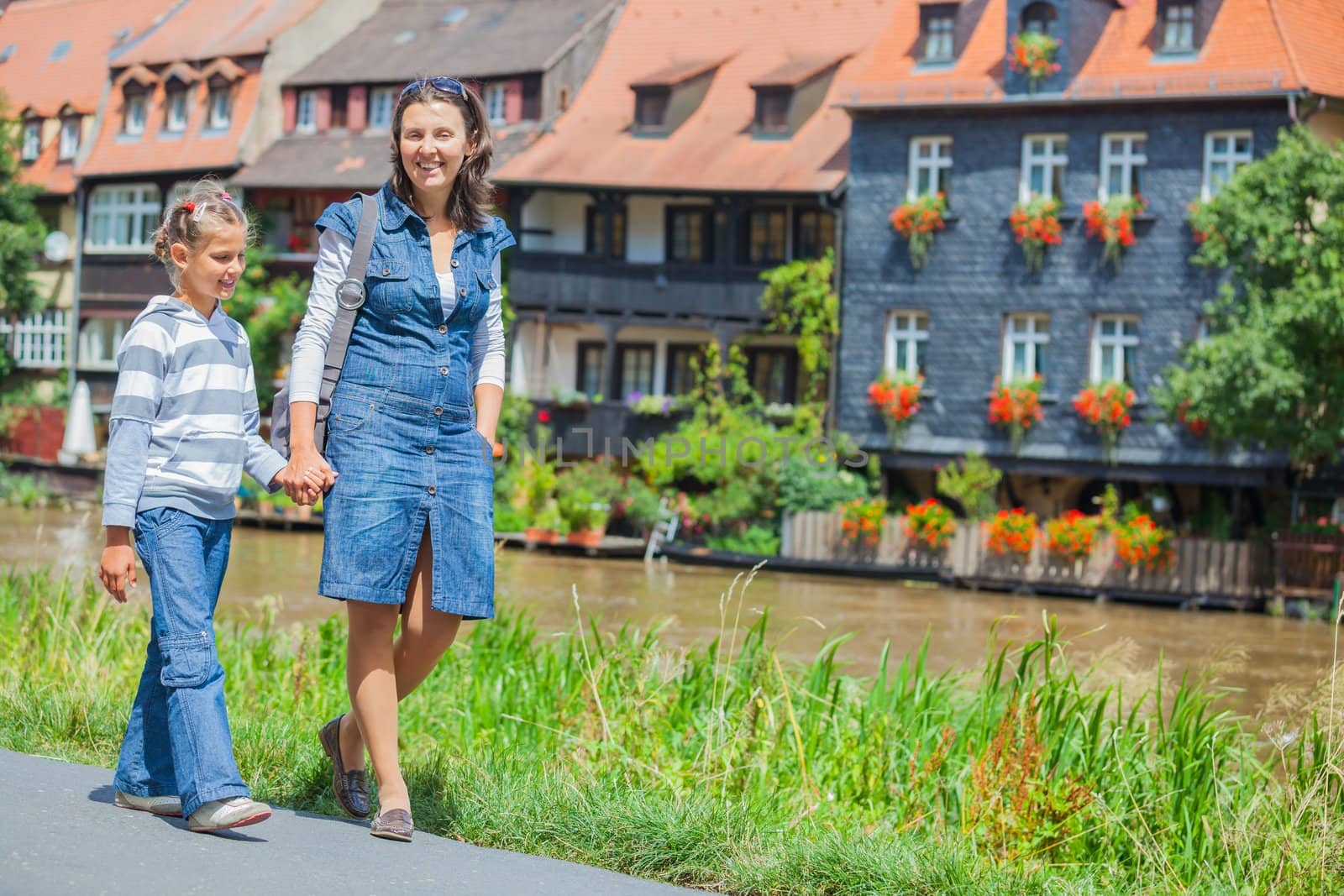 Tourists. Beautiful mother and daughter walking in europe city.