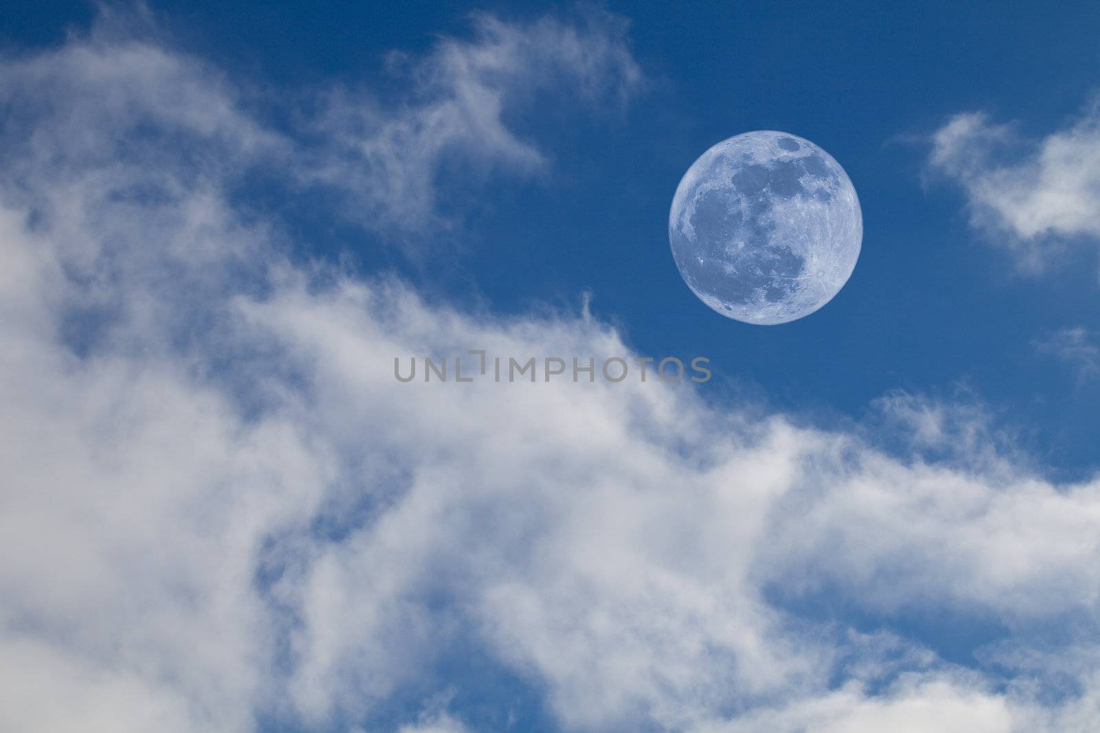 Full Moon on Blue Daytime Sky with Cumulus Clouds
