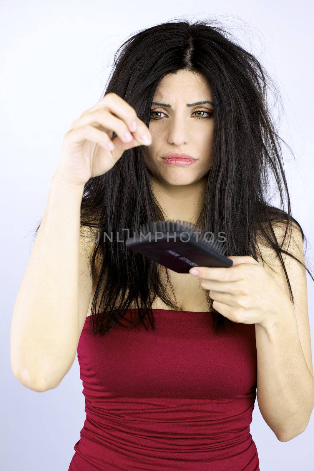 Sad woman holding fallen hair healthcare problems by fmarsicano