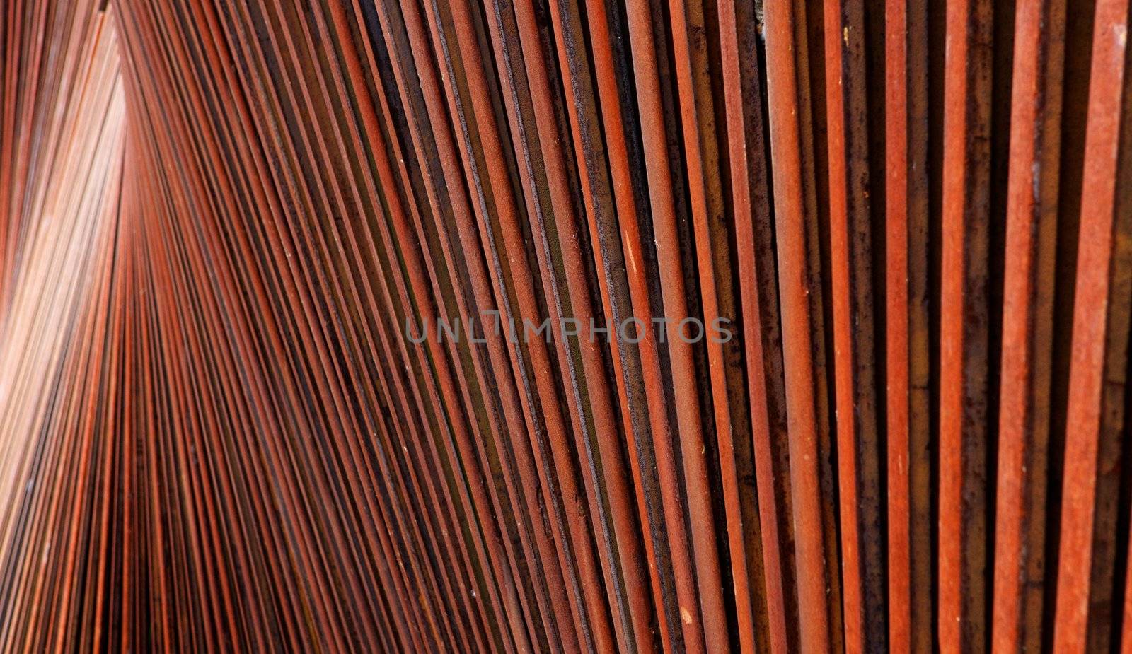 Abstract view of wall of red rusted steel beams