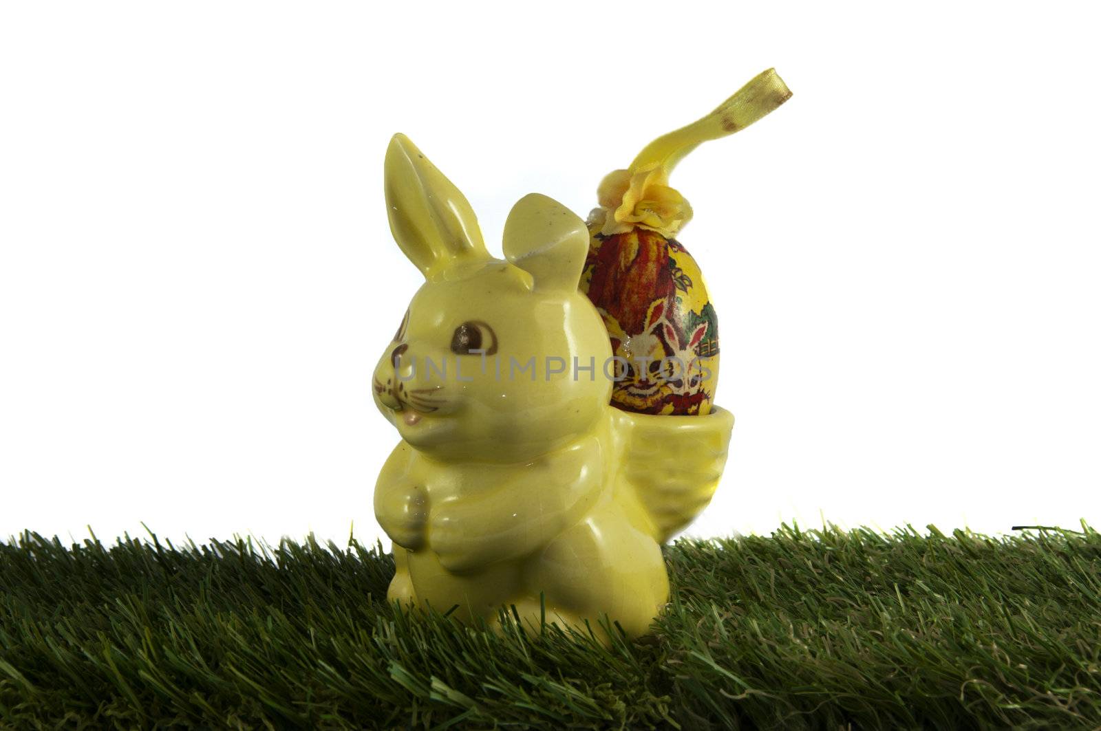 easter bunny with egg in green grass isolated white background