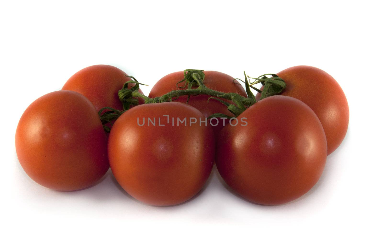 six fresh red tomatoes isolated on white