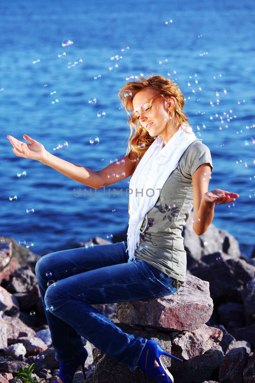 happy blond hair woman sea on background