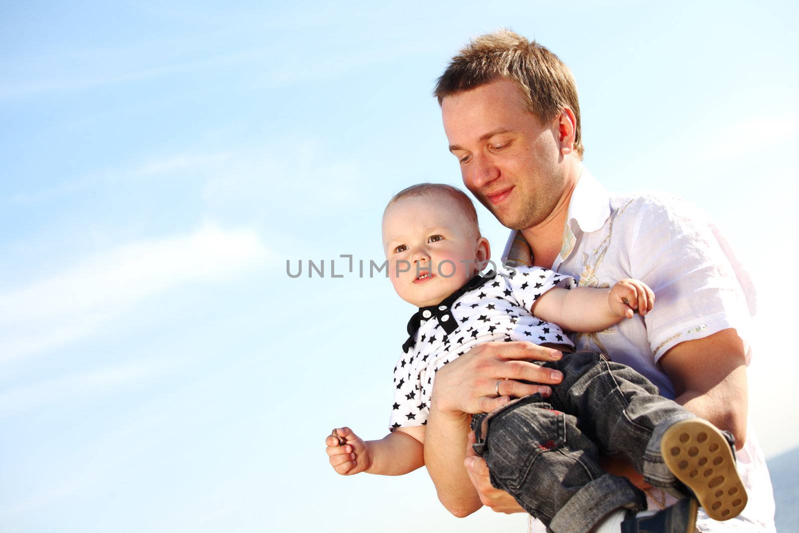 father and son in blue sky