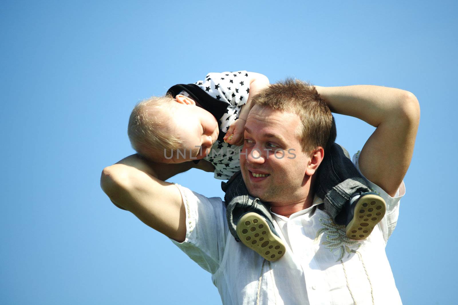 father and son in blue sky