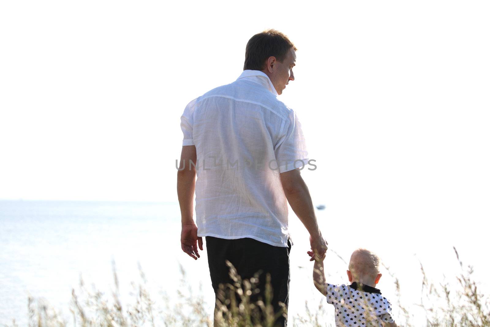 father and son walking on grass