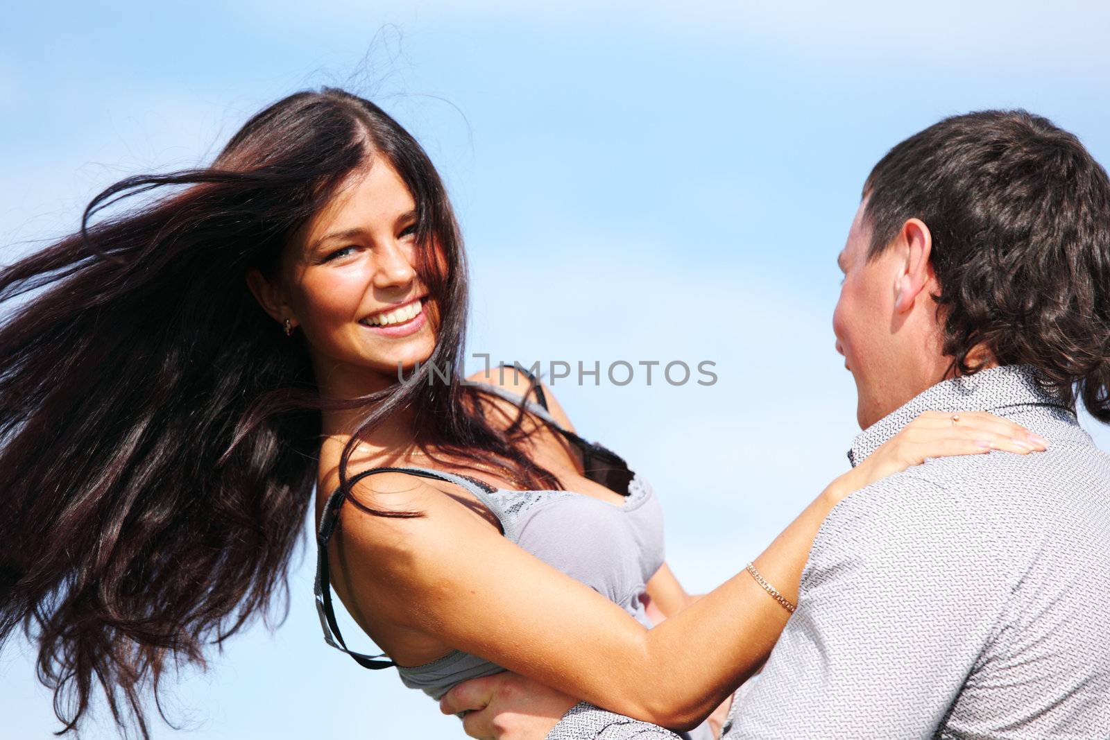 man and woman hug in the sky