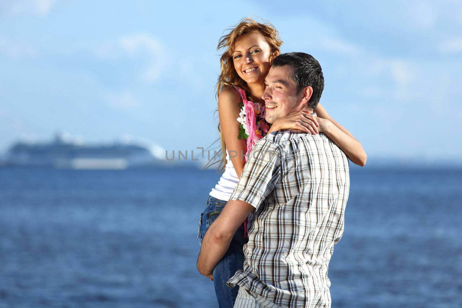 man and woman hug in the sky and sea on sea