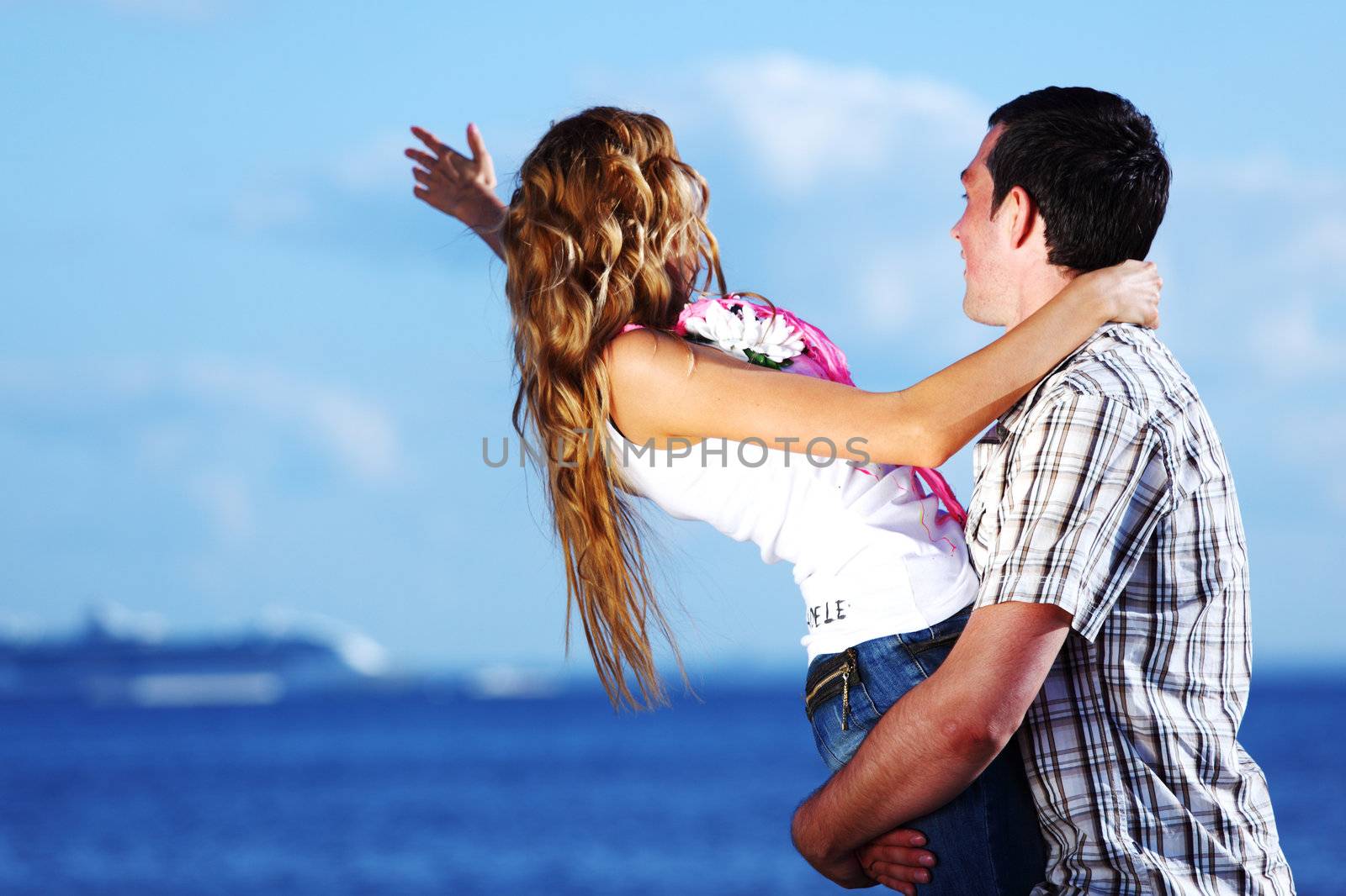 man and woman hug in the sky and sea on sea