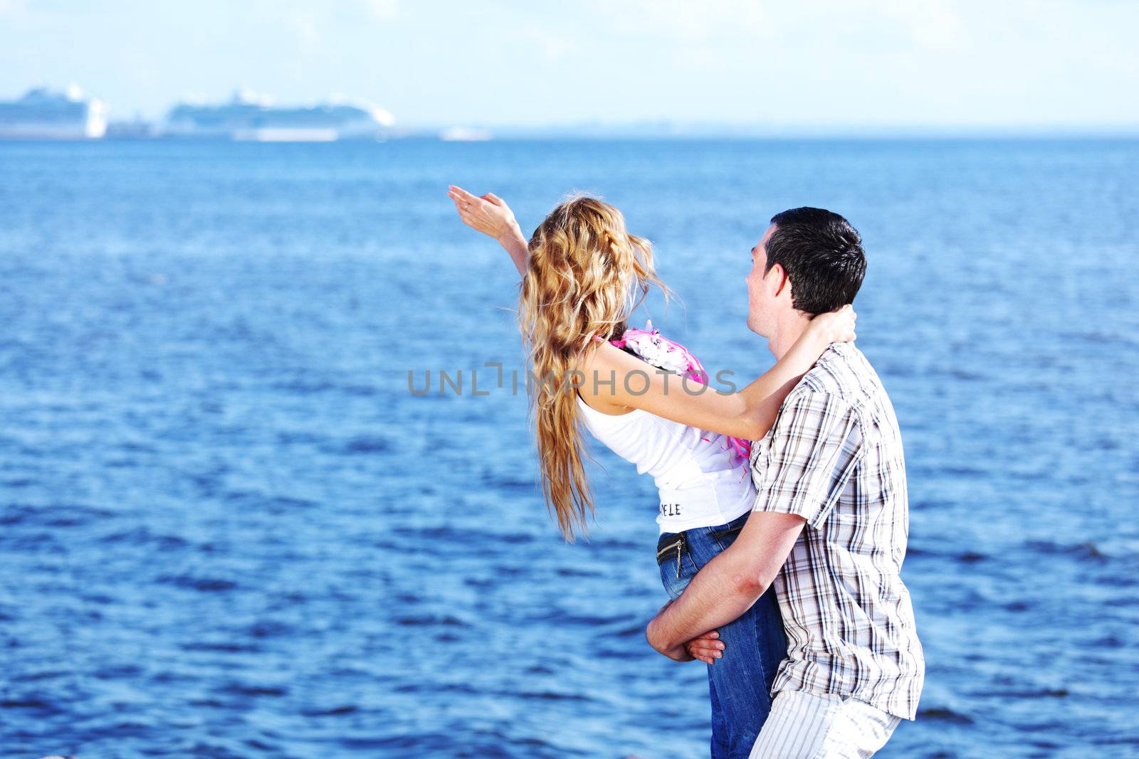 man and woman hug in the sky and sea on sea
