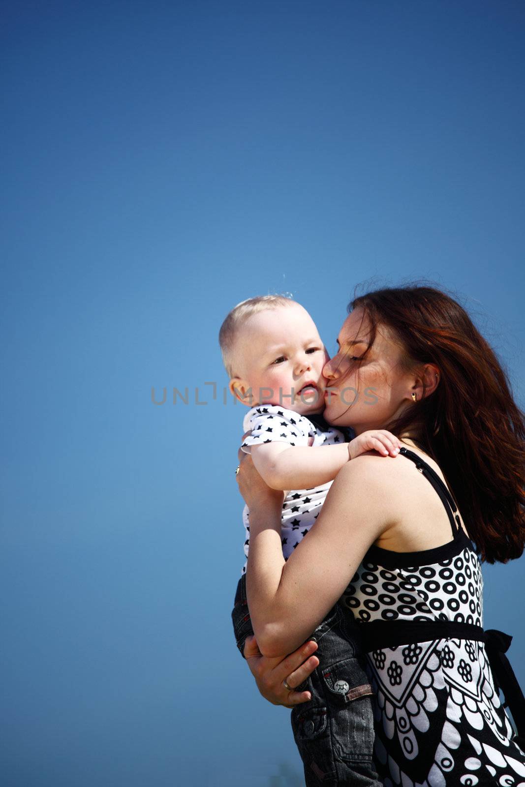 happy mother and son in blue sky