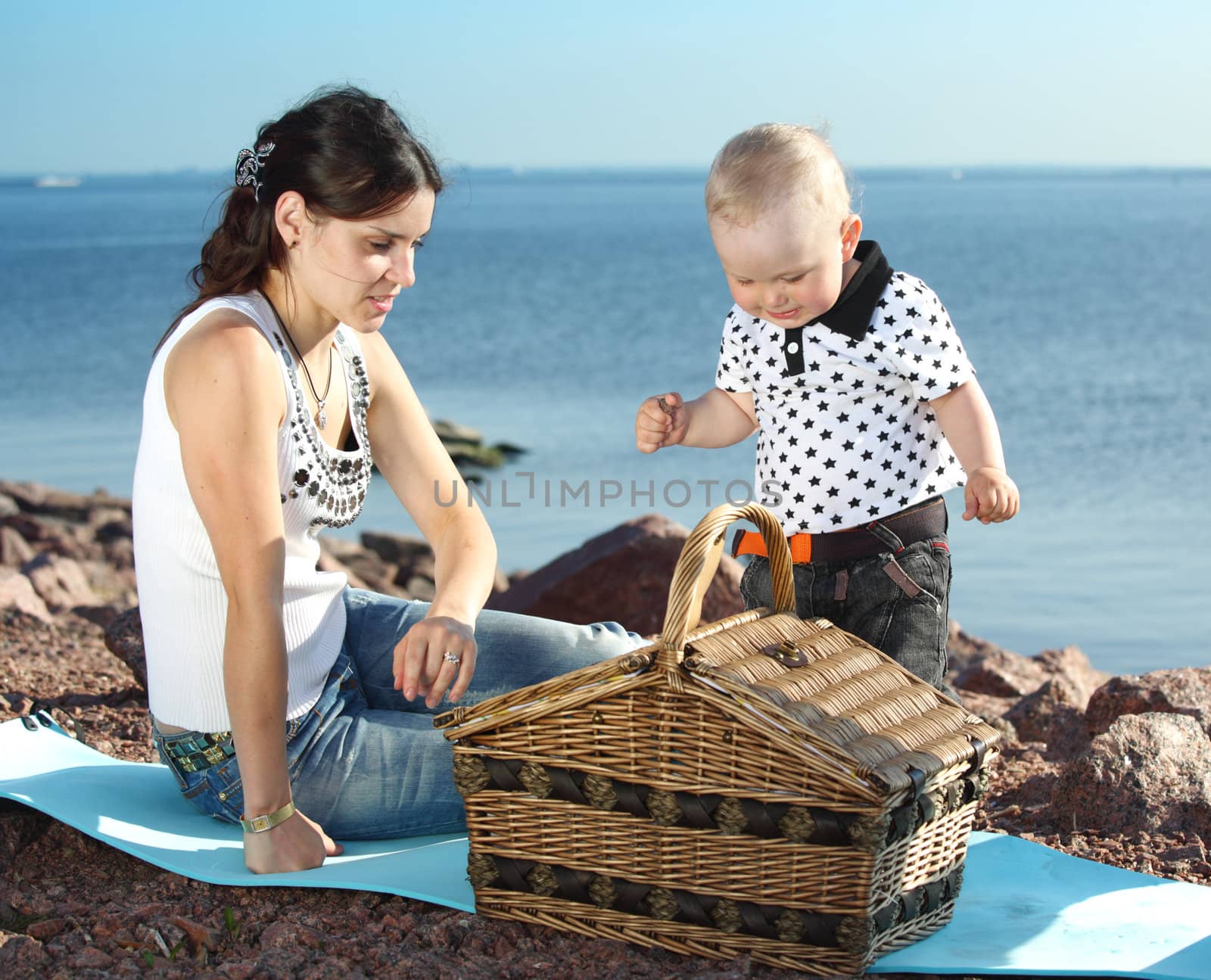 happy mother and son on picnic near sea