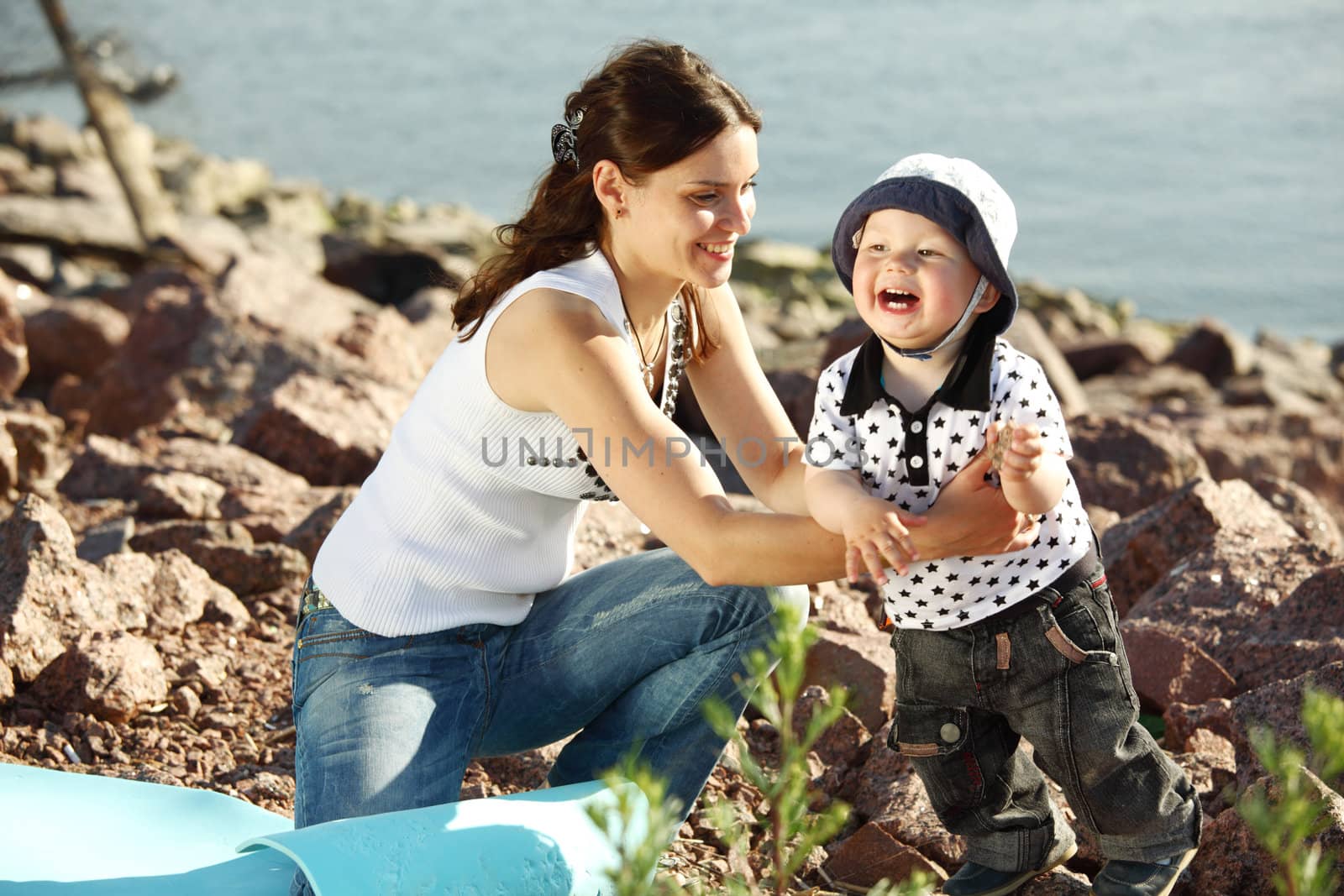 happy mother and son on picnic near sea
