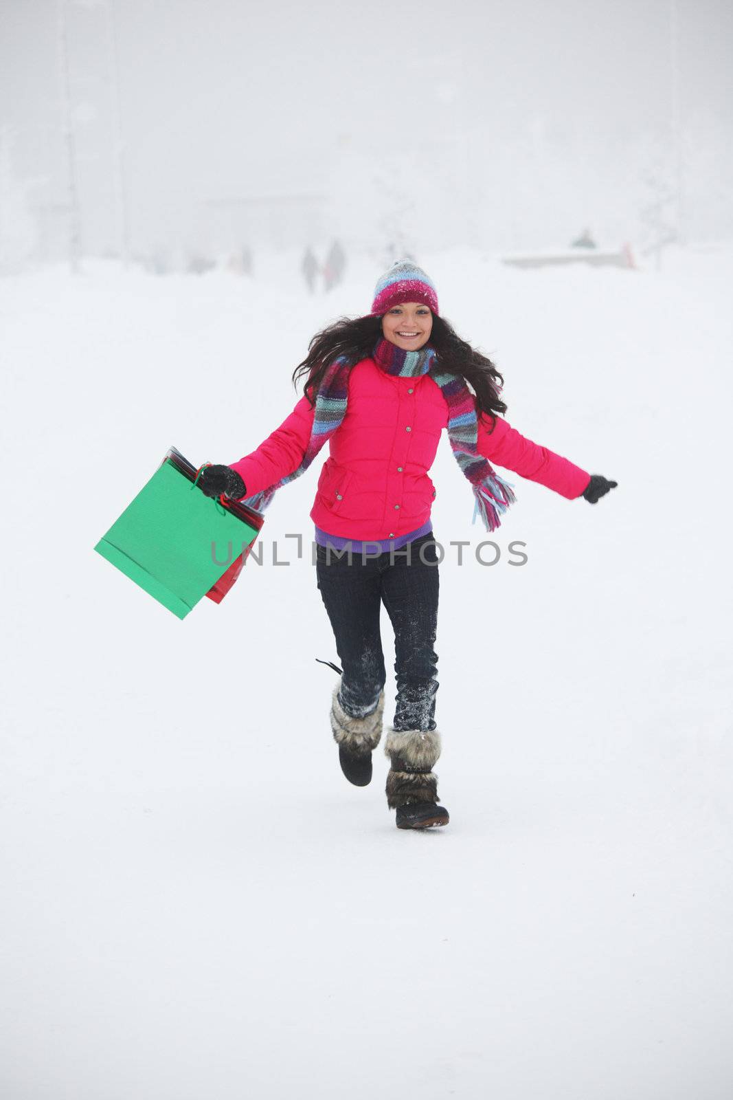 winter girl with gift bags on snow background