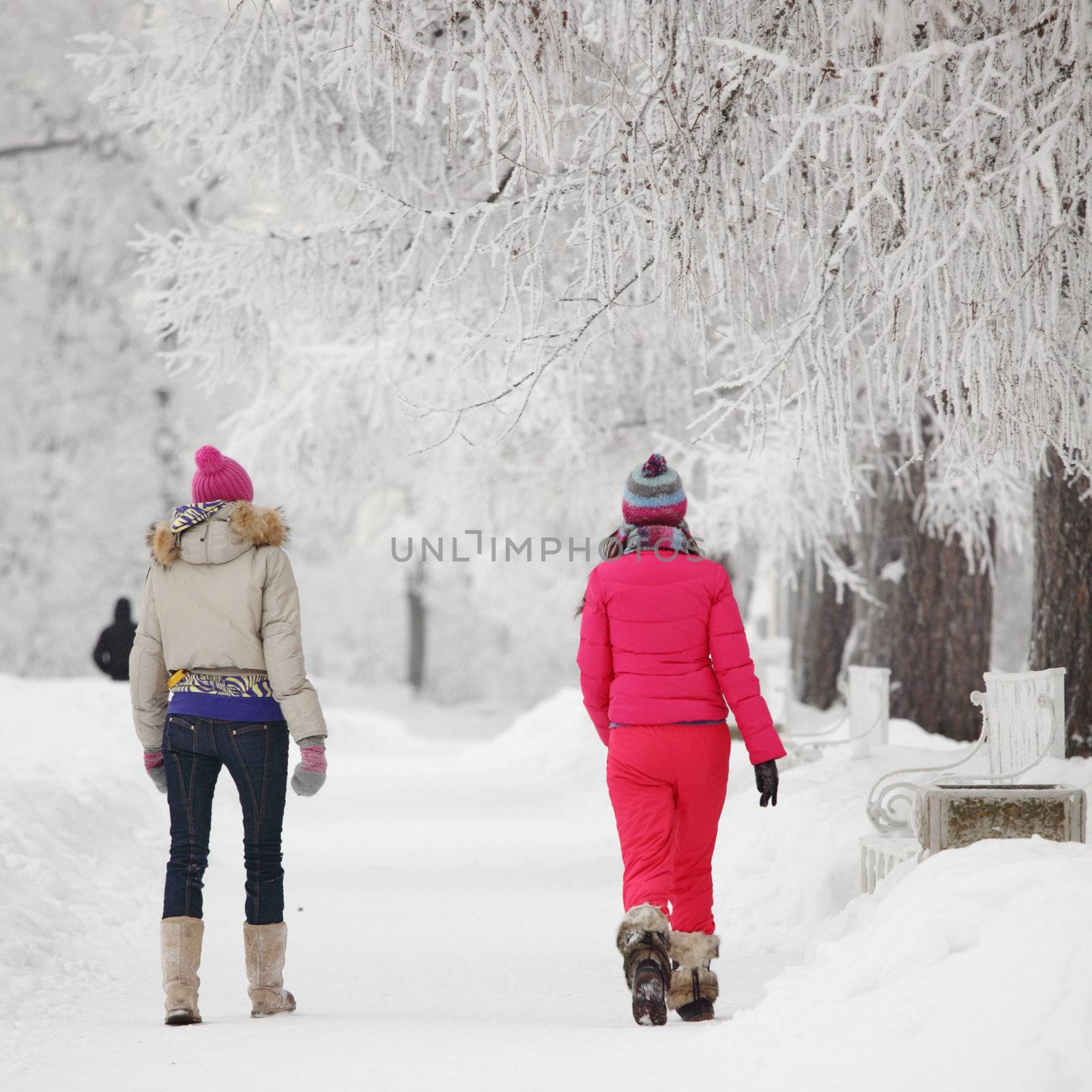 two winter women run by snow frosted alley