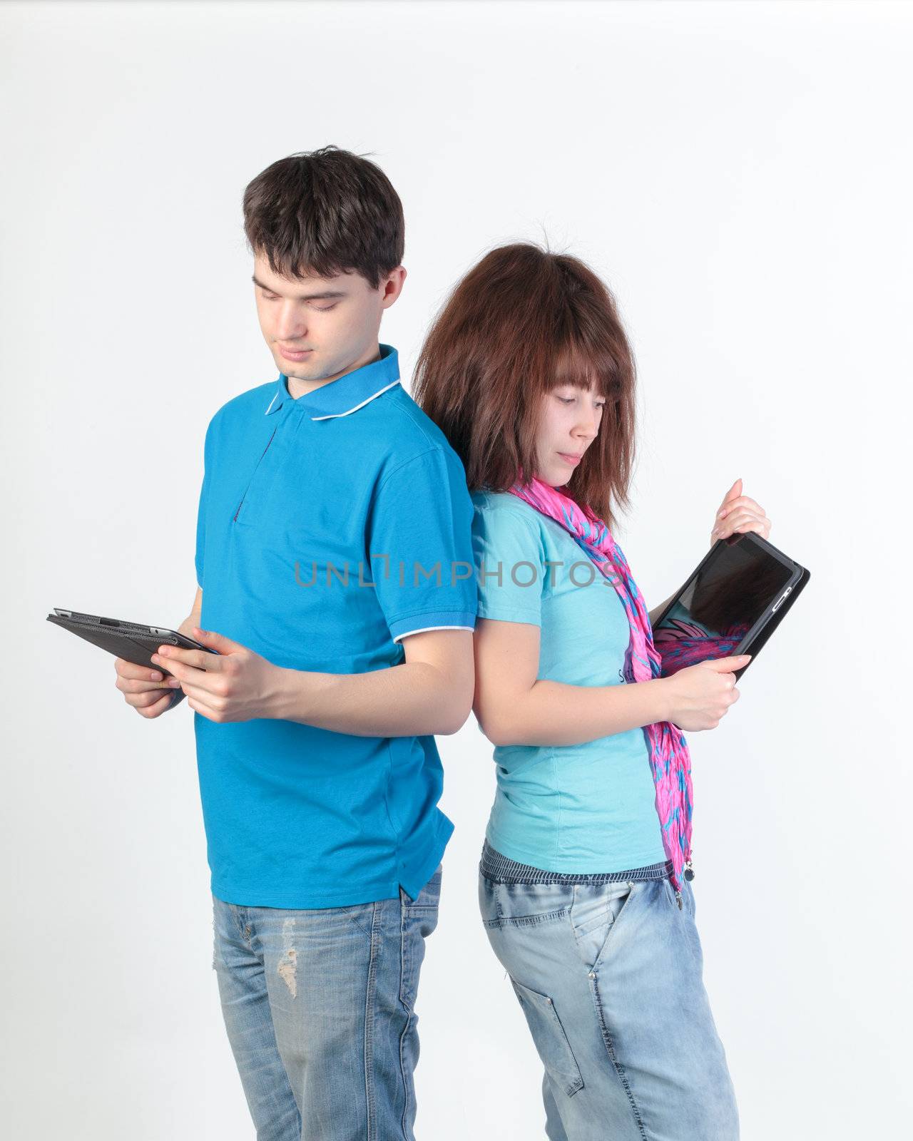 A young couple with a Tablet PC, on gray background