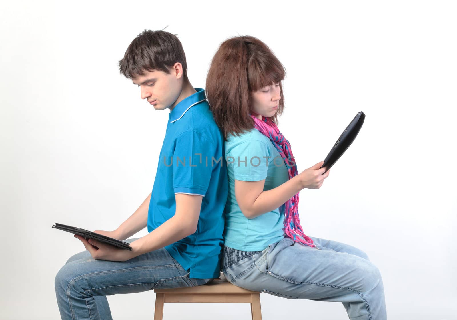 A young couple with a Tablet PC, on gray background