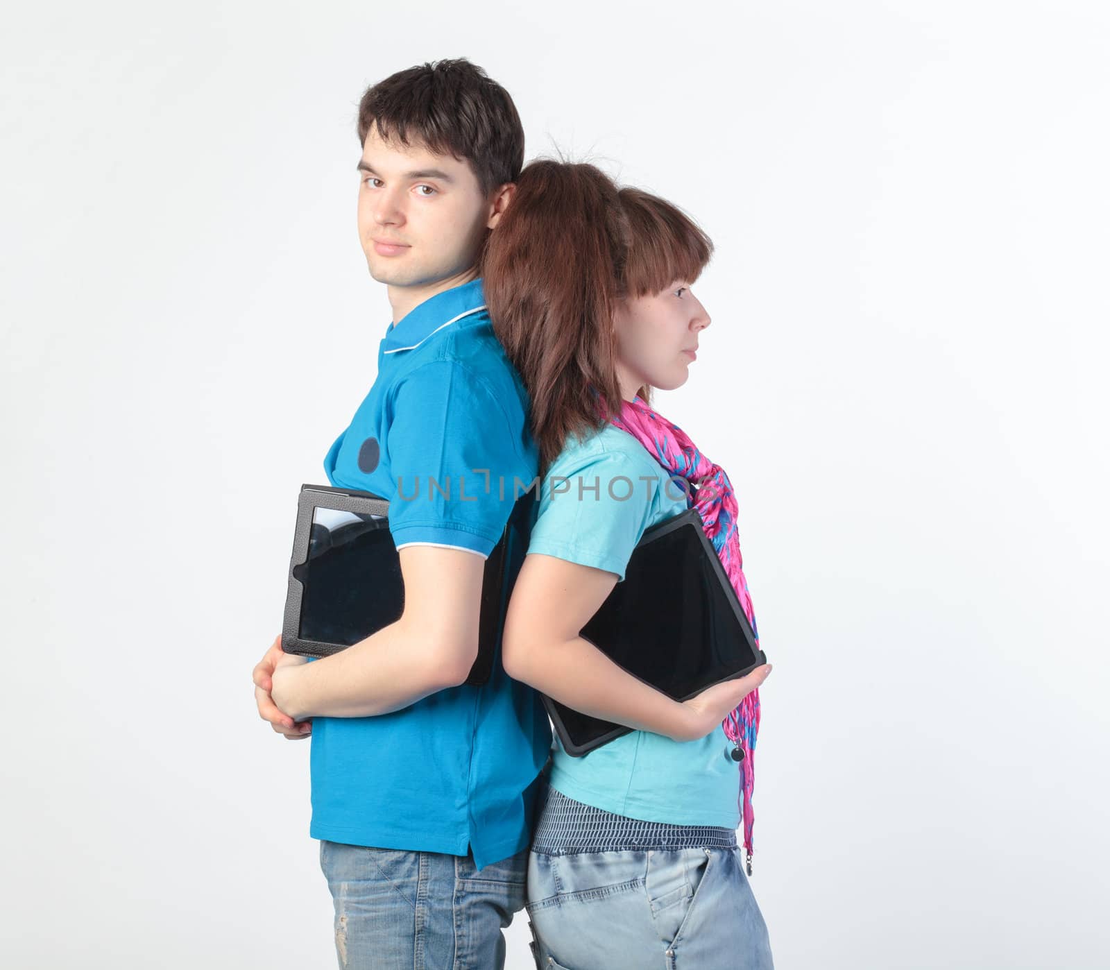 A young couple with a Tablet PC, on gray background