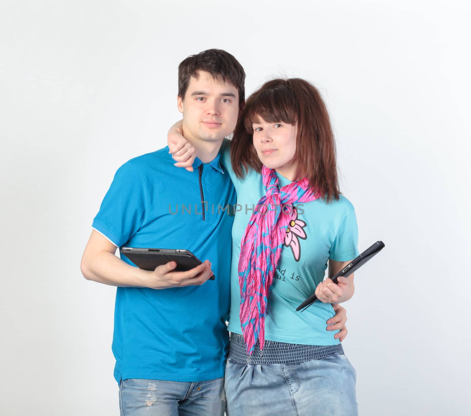 A young couple with a Tablet PC, on gray background