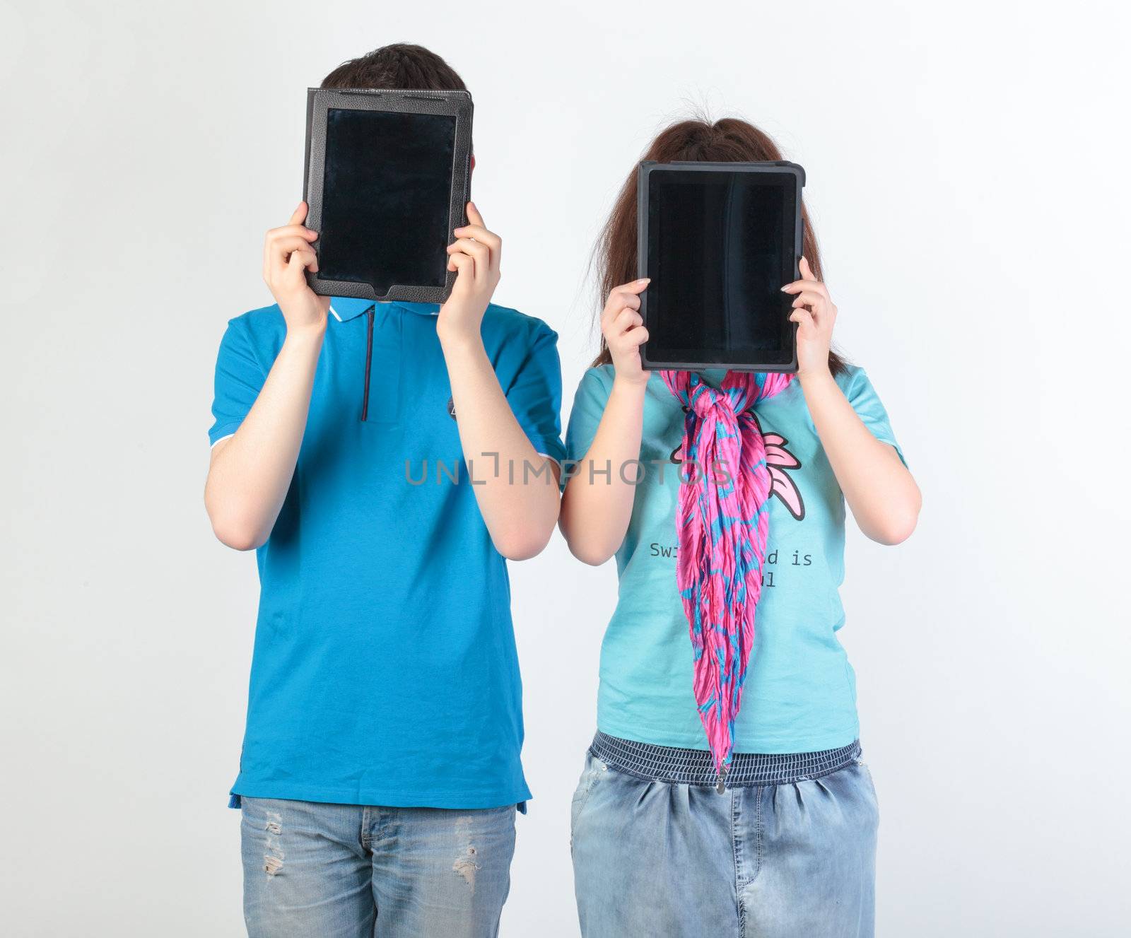 A young couple with a Tablet PC in the form of censor sticker