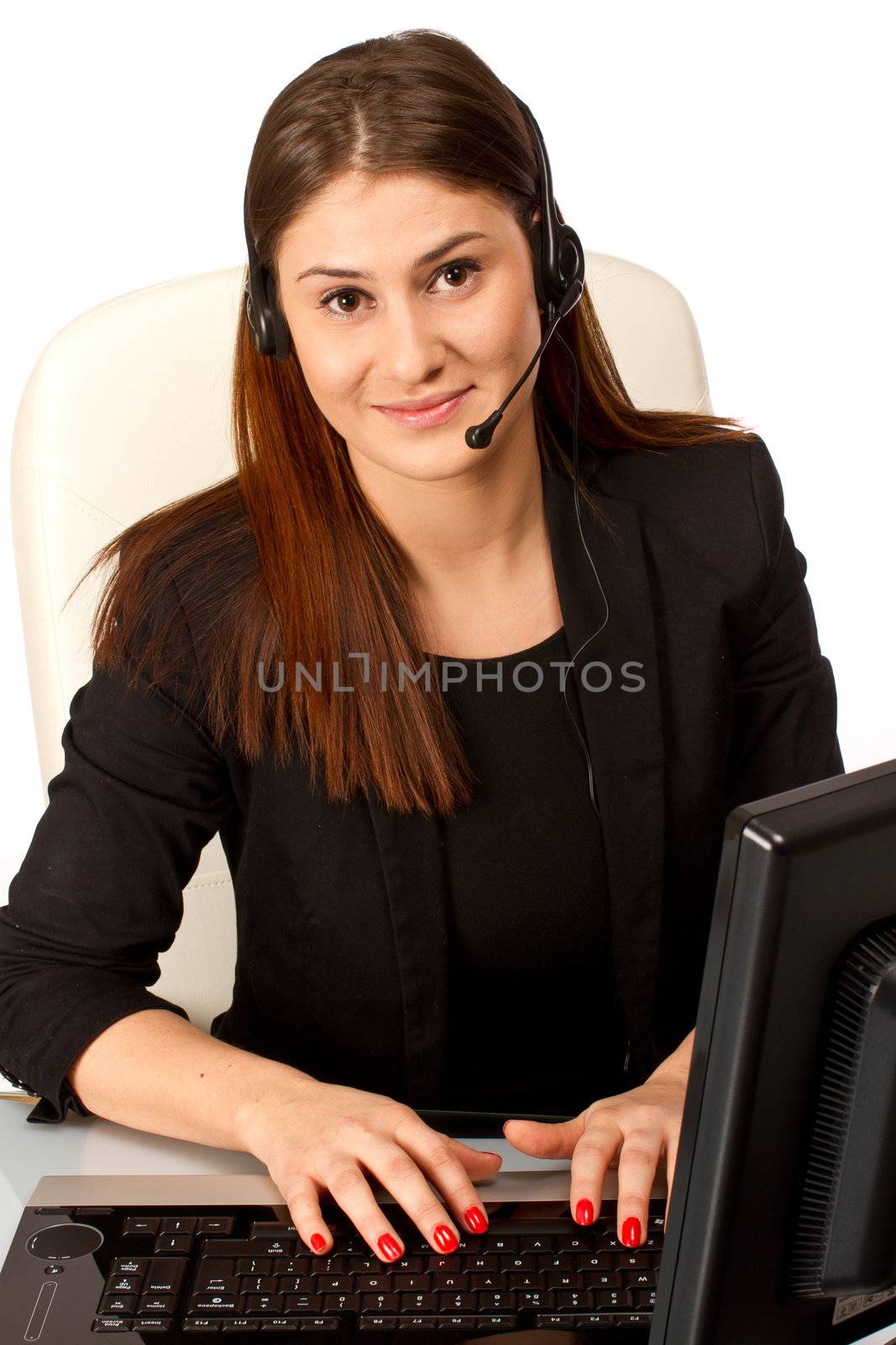 Office worker, secretary at her desk working on a computer