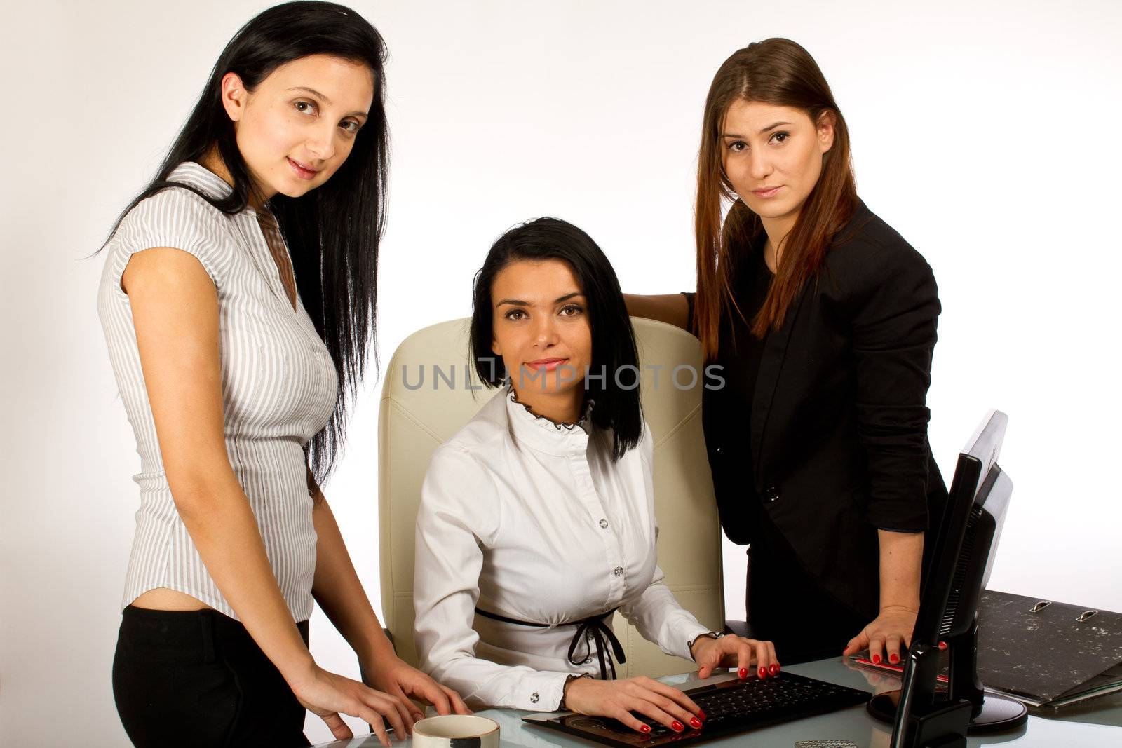 Three  office women working together on a computer