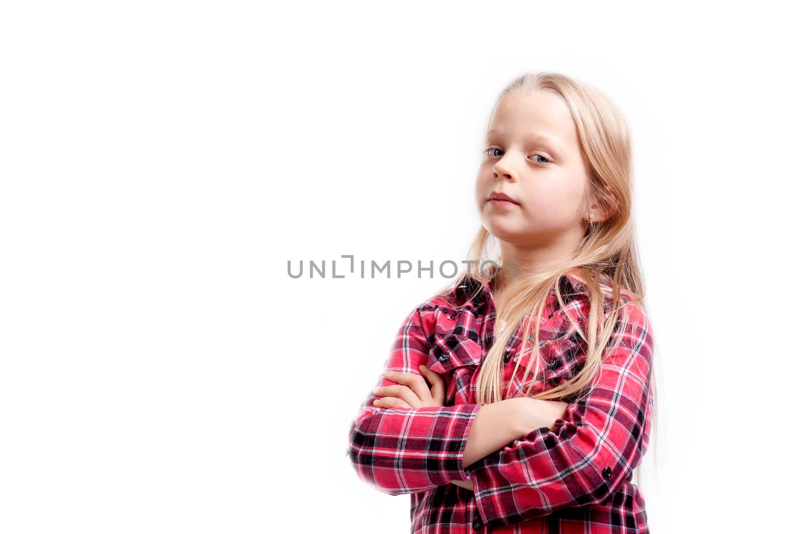 a very serious little girl on white background