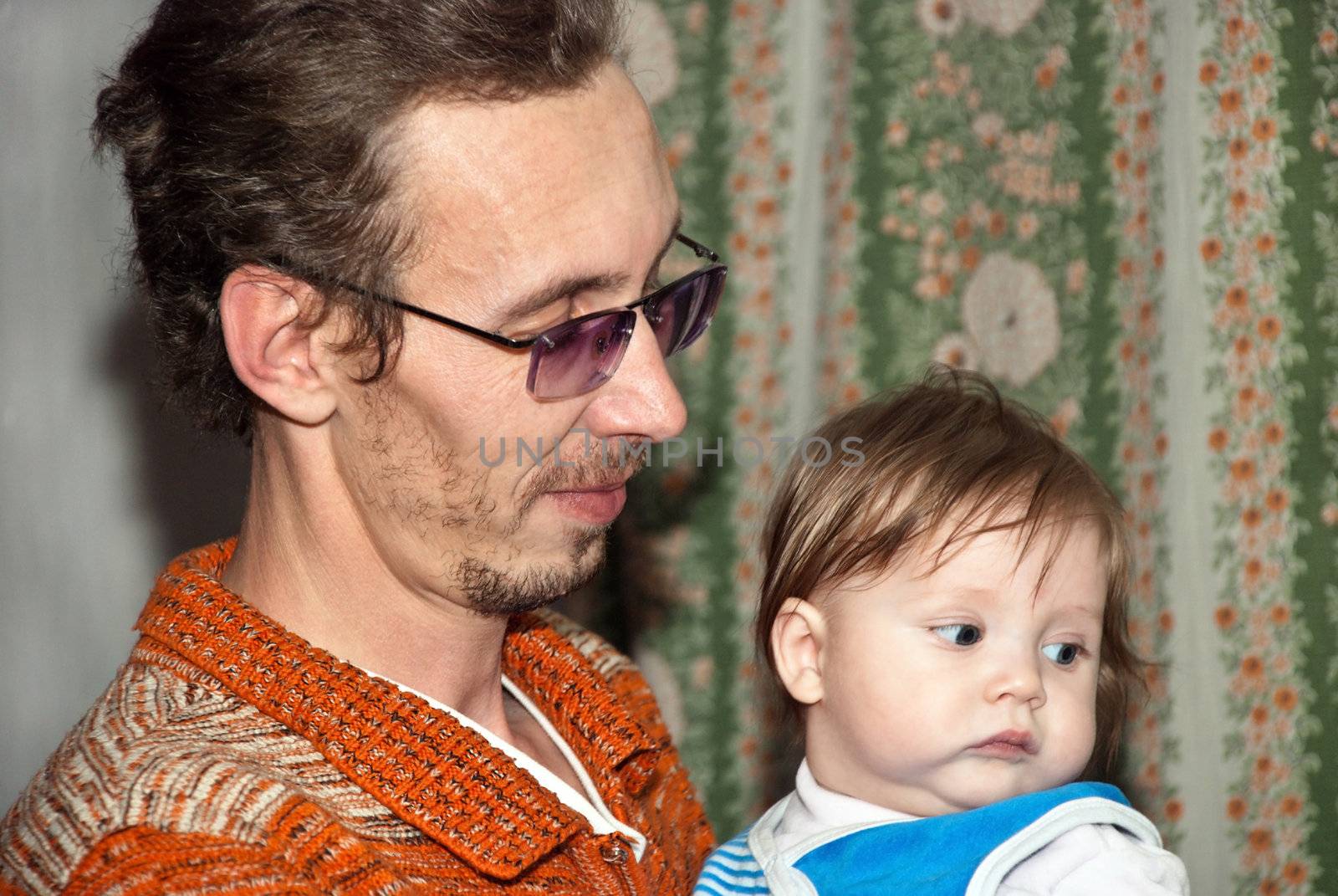 Young handsome man with a baby in her arms.