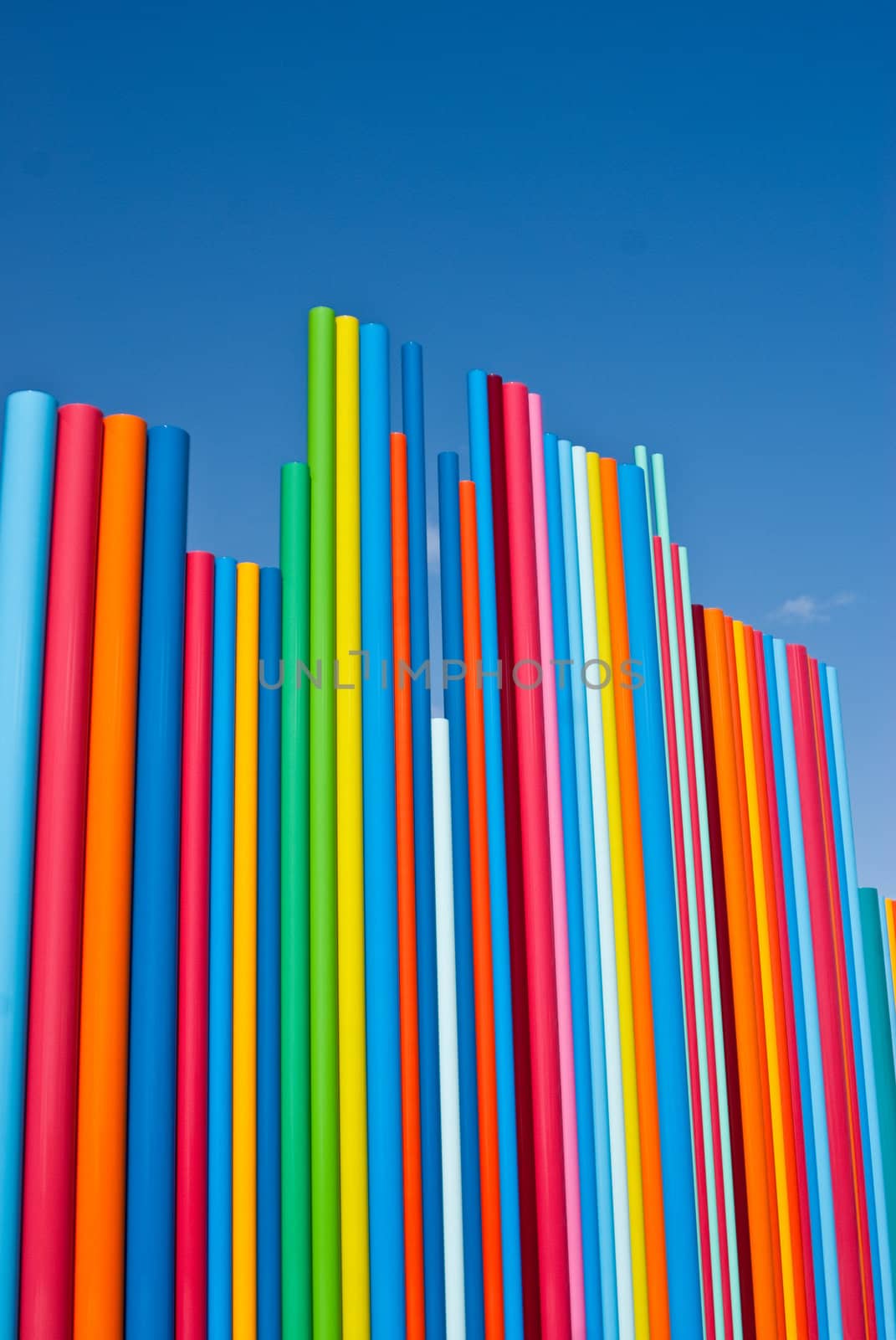 Shining poles of primary colors against the blue sky