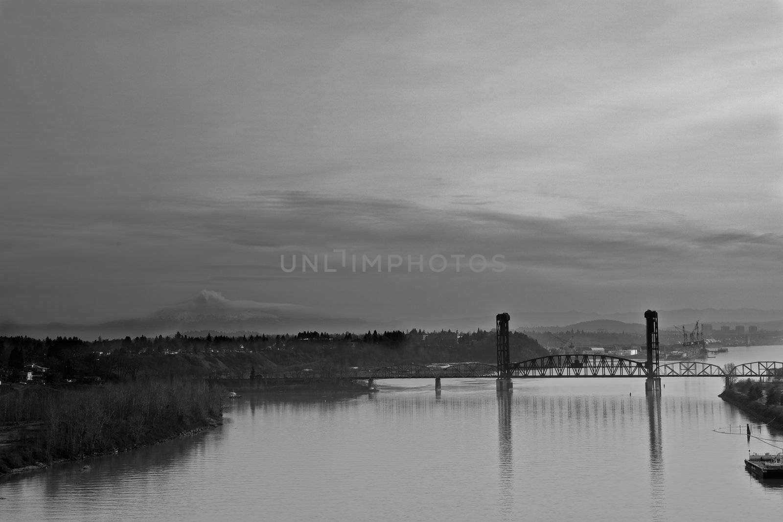 Black and White image of old steel draw bridge in Portland on Willamette river with cloudy background