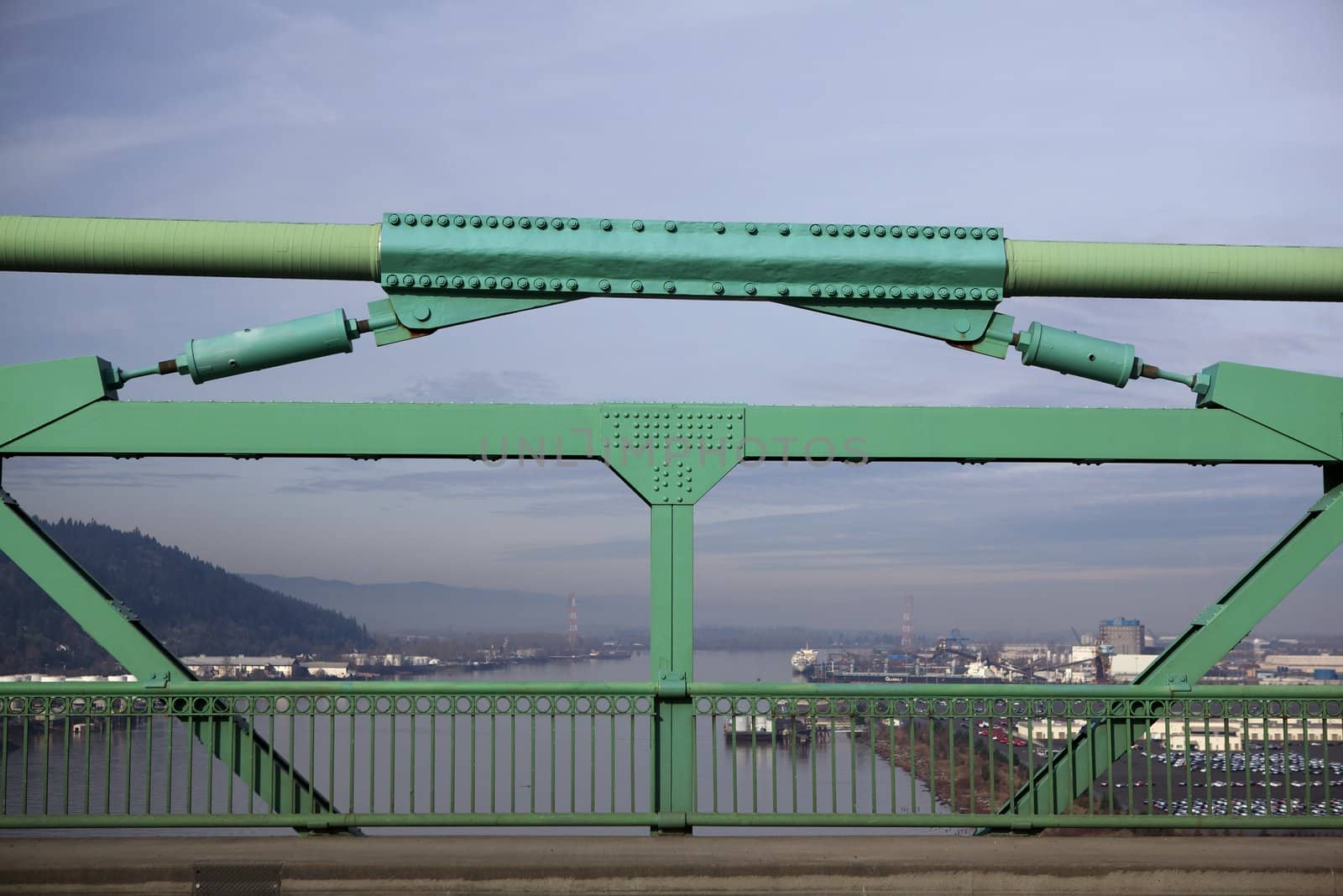 Green Railing St. Johns Bridge with view of one of Willamette River in soft background
