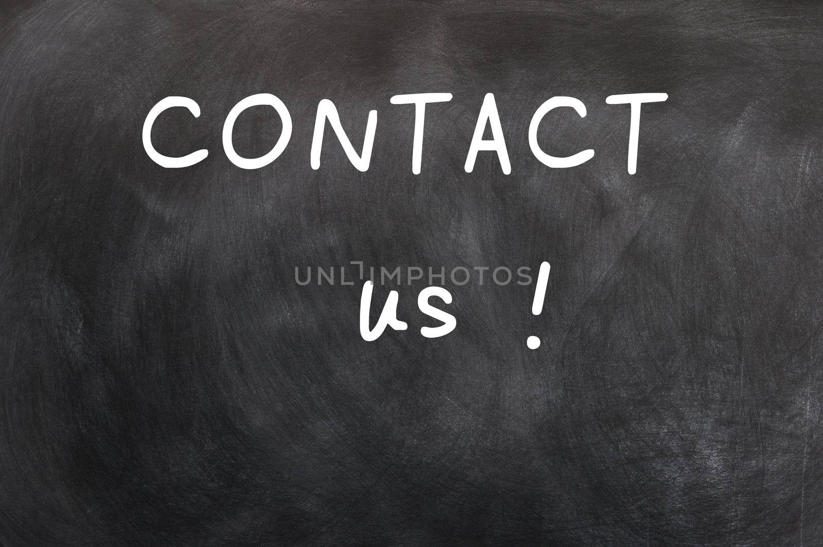 Contact us written with white chalk on a blackboard background