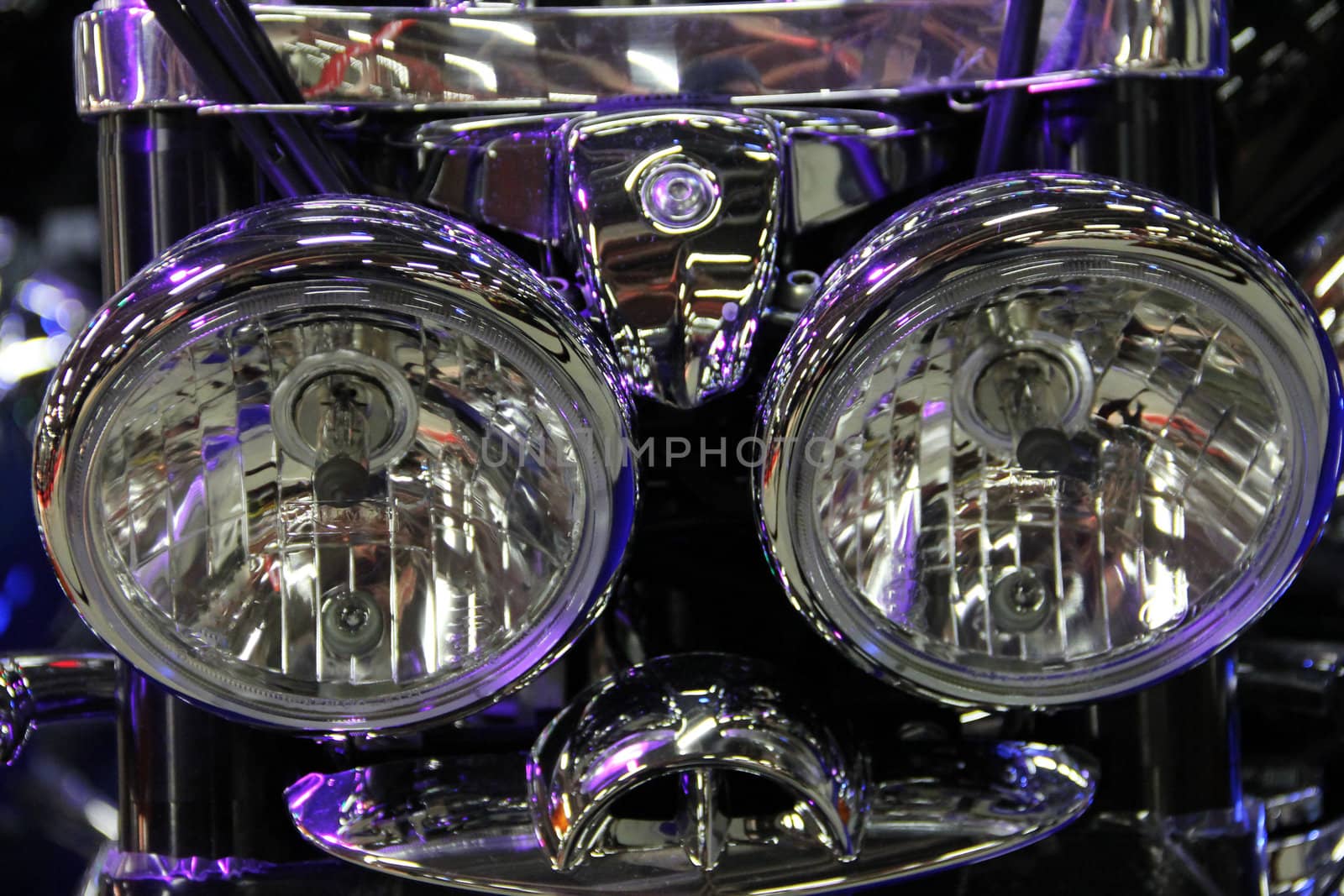 Shiny motorcycle headlight macro close up